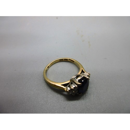 53 - Hallmarked 18ct yellow gold sapphire and diamond ring, 1 large oval faceted sapphire with trefoil 22... 