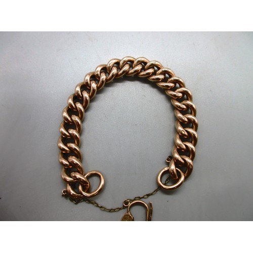 54 - Hallmarked 9ct yellow gold curb chain bracelet with engraved links and padlock style clasp with safe... 