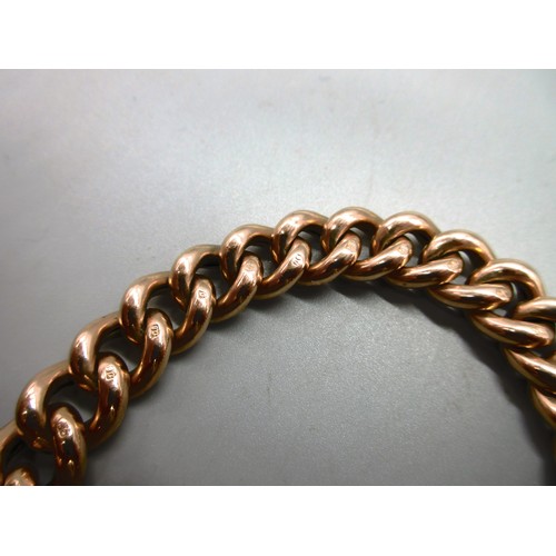 54 - Hallmarked 9ct yellow gold curb chain bracelet with engraved links and padlock style clasp with safe... 