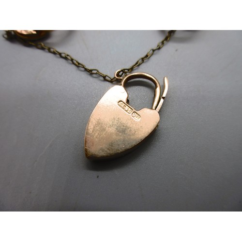 54 - Hallmarked 9ct yellow gold curb chain bracelet with engraved links and padlock style clasp with safe... 