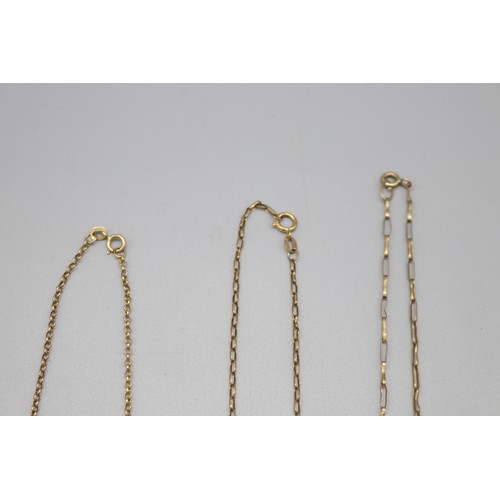 41 - Lot of three 9ct yellow gold religious pendants and chains, comprising a stamped 9ct yellow gold cru... 