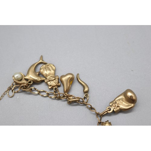 34 - Hallmarked 9ct yellow gold curb link charm bracelet with padlock clasp, set with the following charm... 