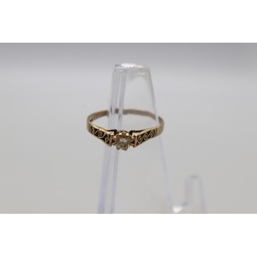 29 - Lot of four hallmarked 9ct yellow gold rings, comprising a CZ solitaire ring with scrollwork shoulde... 