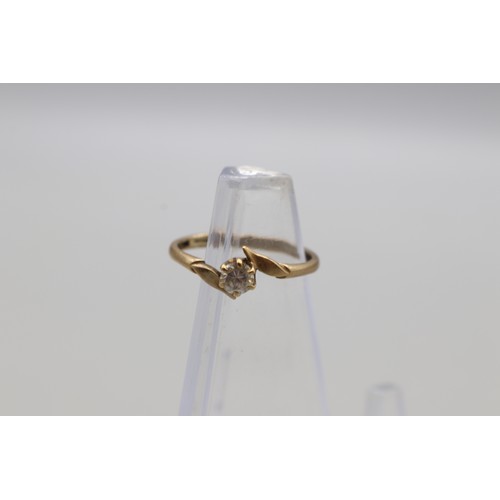 29 - Lot of four hallmarked 9ct yellow gold rings, comprising a CZ solitaire ring with scrollwork shoulde... 