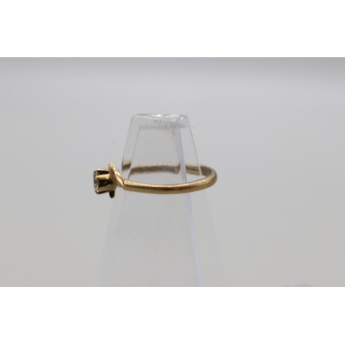 29 - Lot of four hallmarked 9ct yellow gold rings, comprising a CZ solitaire ring with scrollwork shoulde... 