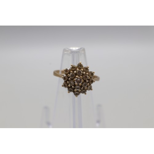 27 - Three hallmarked 9ct yellow gold cubic zirconia cluster rings, comprising a hexagonal flower cluster... 