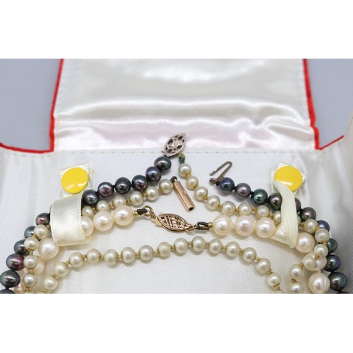 56 - Lot of three pearl necklets, comprising an individually strung white pearl necklet with stamped 10k ... 