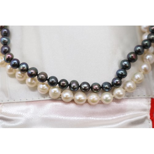 56 - Lot of three pearl necklets, comprising an individually strung white pearl necklet with stamped 10k ... 