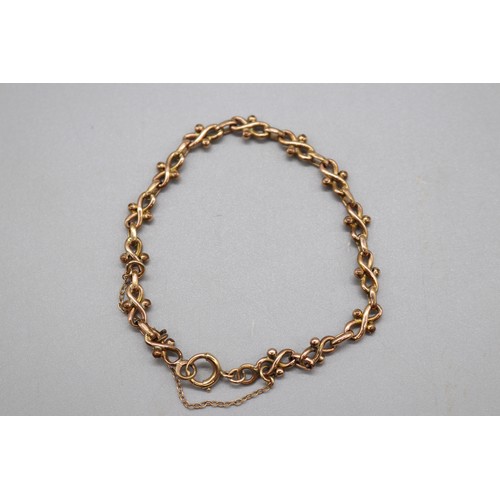 47 - Yellow metal infinity link bracelet with safety chain, in a fitted velvet box, weight 6.89g
Bradley'... 