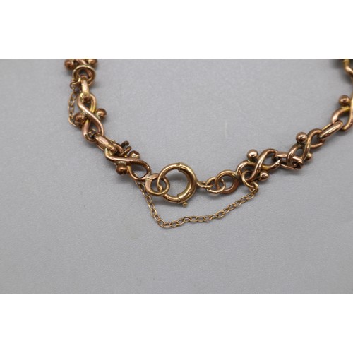 47 - Yellow metal infinity link bracelet with safety chain, in a fitted velvet box, weight 6.89g
Bradley'... 