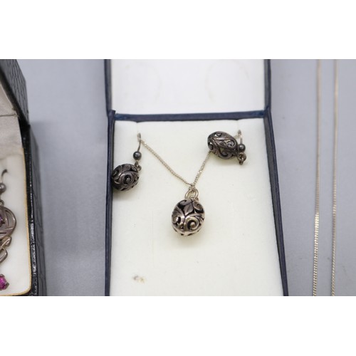 57 - Lot of silver items, comprising a stamped sterling silver scrollwork hollow egg earrings and pendant... 