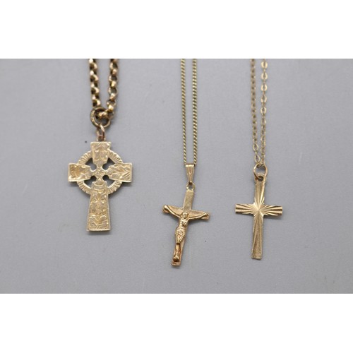 58 - Lot of three gold crosses, comprising a 9ct yellow gold Celtic cross pendant with hand-engraved fron... 