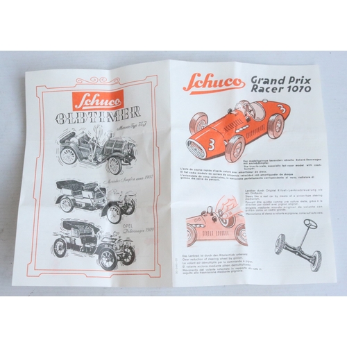 Two modern reissued clockwork racing car models from Schuco to include ...