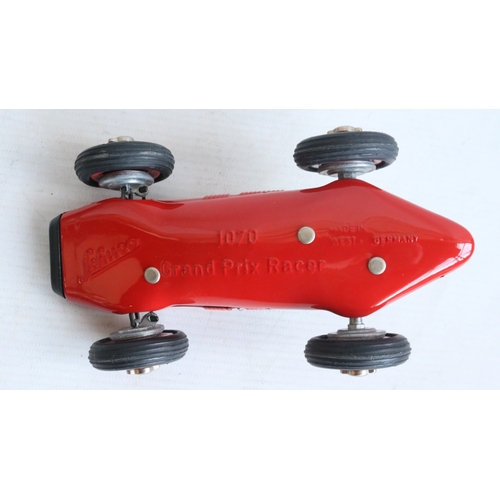 Two modern reissued clockwork racing car models from Schuco to include ...