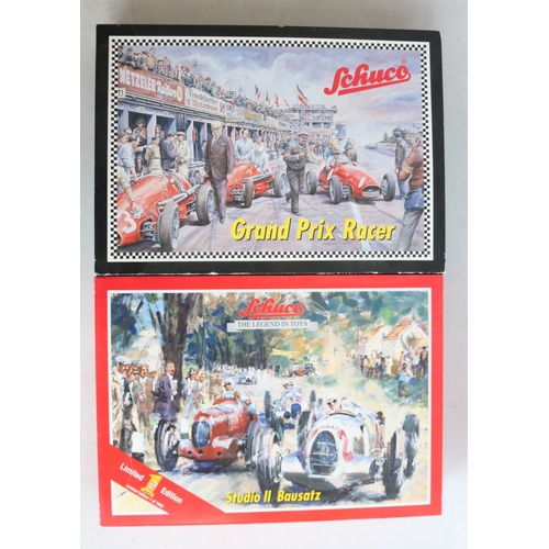Two modern reissued clockwork racing car models from Schuco to include ...