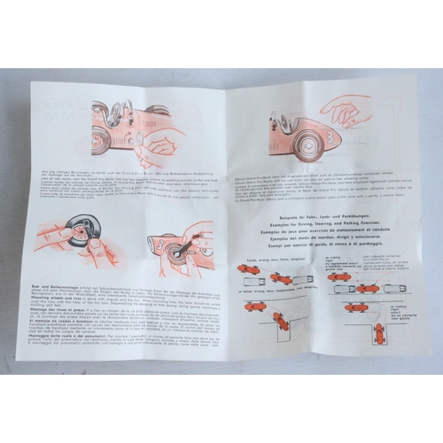 Two modern reissued clockwork racing car models from Schuco to include ...