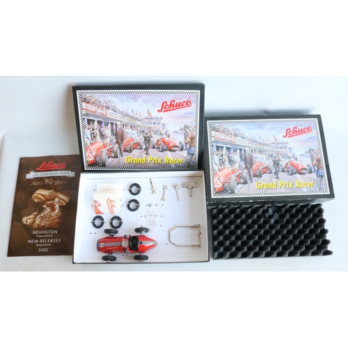 Two modern reissued clockwork racing car models from Schuco to include ...
