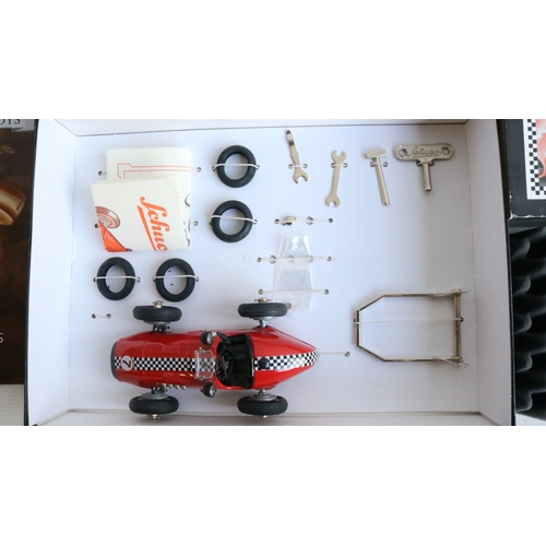 Two modern reissued clockwork racing car models from Schuco to include ...