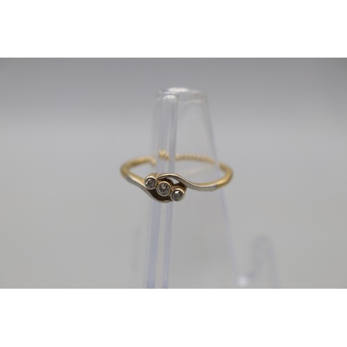 7 - Stamped 18ct yellow gold and platinum trilogy ring, set with three small bezel-set diamonds, size Q,... 