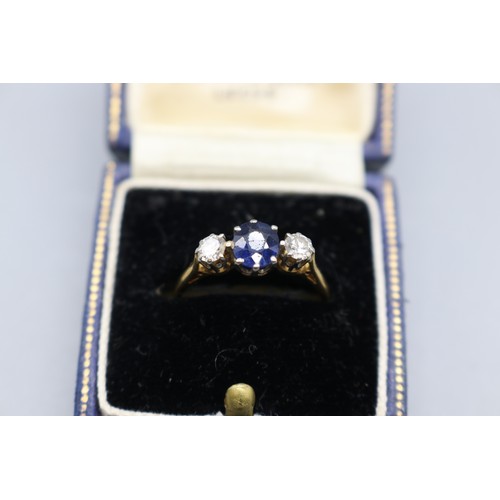 11 - Stamped 18ct yellow gold sapphire and diamond trilogy ring with platinum head, set with a central ov... 