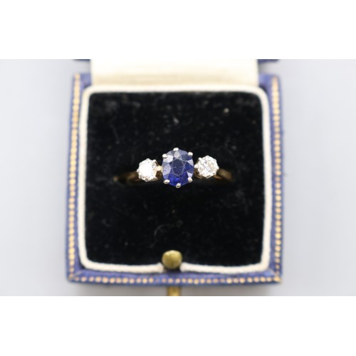 11 - Stamped 18ct yellow gold sapphire and diamond trilogy ring with platinum head, set with a central ov... 