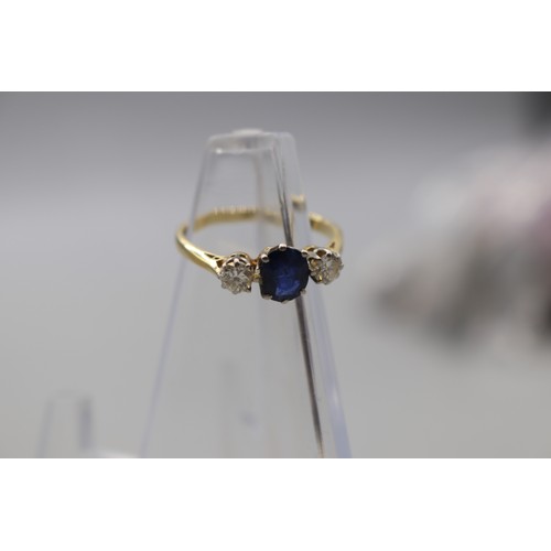 11 - Stamped 18ct yellow gold sapphire and diamond trilogy ring with platinum head, set with a central ov... 