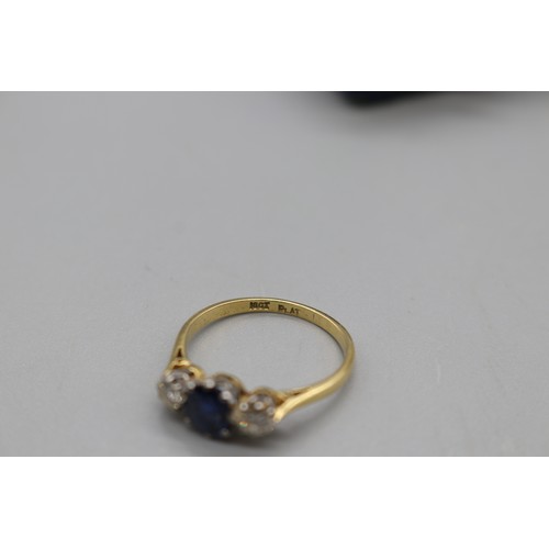 11 - Stamped 18ct yellow gold sapphire and diamond trilogy ring with platinum head, set with a central ov... 