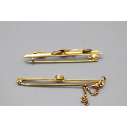 20 - Two gold bar brooches, comprising a stamped 9ct yellow gold bar brooch with a millgrain bezel-set op... 