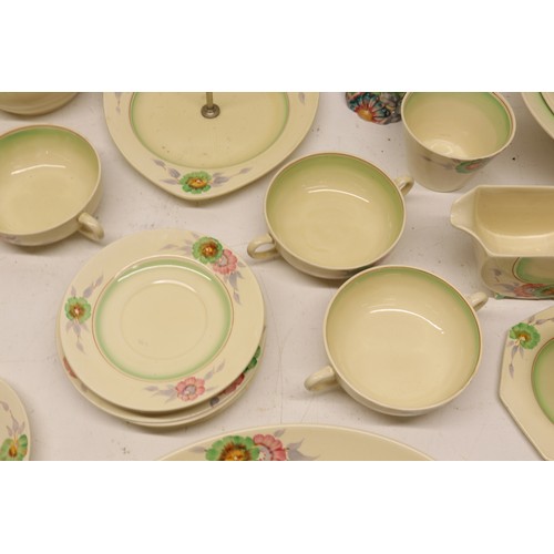 795 - Collection of Clarice Cliff tea and dinner ware, incl. honey pot, two teapots, teacups, soup cups, s... 