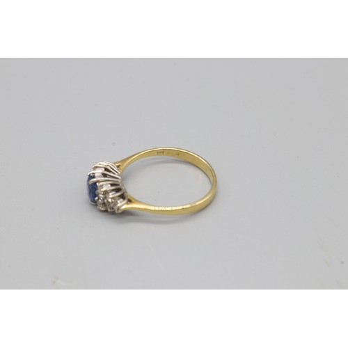 4 - A stamped 18ct yellow gold sapphire and diamond ring, set with a central Ceylon sapphire flanked by ... 