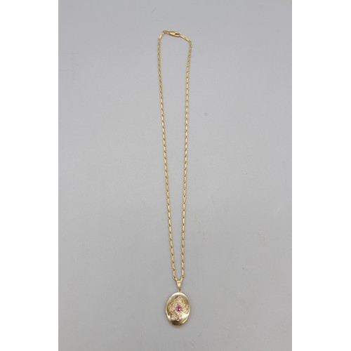 5 - A hallmarked 9ct yellow gold ruby and diamond locket on a hallmarked 9ct yellow gold barleycorn link... 