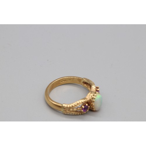 9 - A hallmarked 9ct yellow gold ring, set with opal and amethyst, with decorative split shoulders. Ring... 