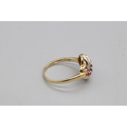  A hallmarked 9ct yellow gold ruby and diamond cocktail ring, designed with a twisted wave motif. Rin... 