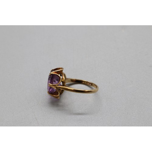 32 - A hallmarked 9ct yellow gold amethyst suite, comprising a petal-set cocktail ring with a large facet... 