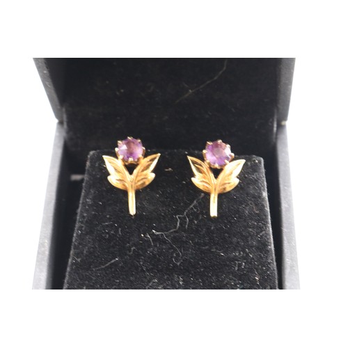 32 - A hallmarked 9ct yellow gold amethyst suite, comprising a petal-set cocktail ring with a large facet... 
