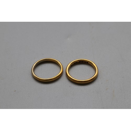 15 - A pair of 22ct yellow gold court wedding bands, comprising a hallmarked Birmingham example dated 184... 