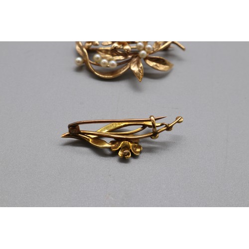 16 - A lot of two hallmarked gold seed pearl brooches, comprising a stamped 15ct yellow gold multi-seed p... 