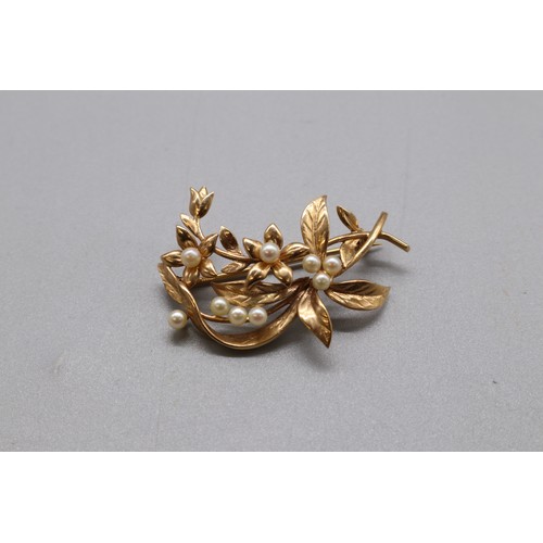 16 - A lot of two hallmarked gold seed pearl brooches, comprising a stamped 15ct yellow gold multi-seed p... 