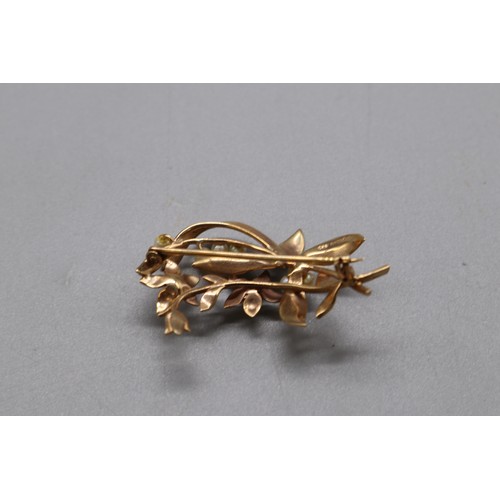 16 - A lot of two hallmarked gold seed pearl brooches, comprising a stamped 15ct yellow gold multi-seed p... 