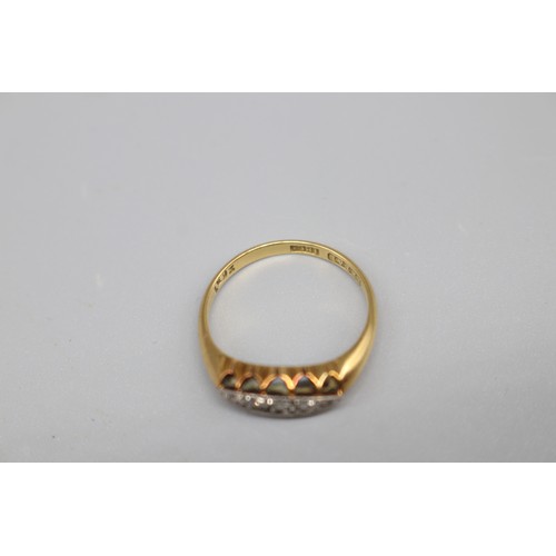 40 - A hallmarked 18ct yellow gold five-stone diamond boat-head ring, set with five graduated round brill... 