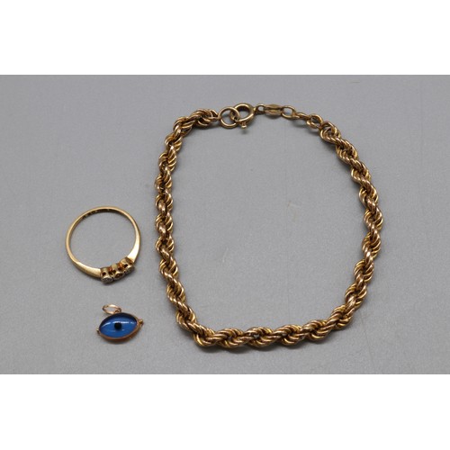 41 - Mixed gold jewellery, comprising a hallmarked 18ct yellow gold diamond trilogy ring, size O, the cen... 