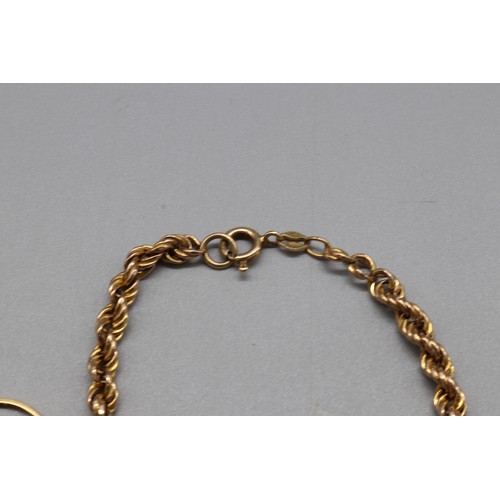 41 - Mixed gold jewellery, comprising a hallmarked 18ct yellow gold diamond trilogy ring, size O, the cen... 