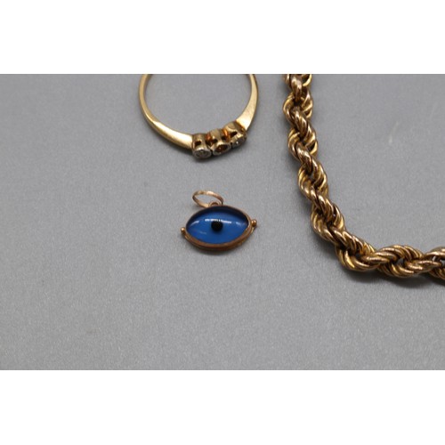 41 - Mixed gold jewellery, comprising a hallmarked 18ct yellow gold diamond trilogy ring, size O, the cen... 