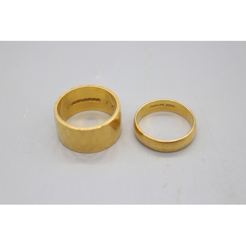 2 - Two hallmarked 22ct yellow gold wedding bands, comprising a 10mm diamond-faceted band, size O (13.48... 