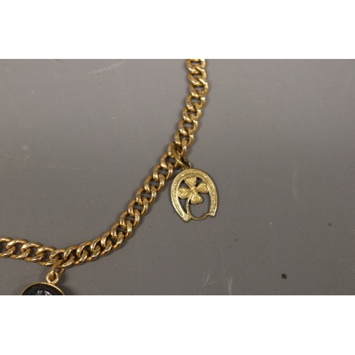 1 - 18ct yellow gold charm bracelet, Eastern stamped and XRF tested, comprising a solid curb link bracel... 