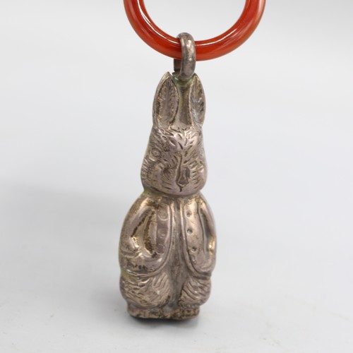 Two silver baby rattles inc. one in Peter Rabbit form with polished ...