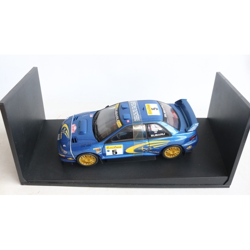 49 - Two 1/18th scale diecast WRC model cars from AutoArt to include 89992 1999 Subaru Impreza #5 Burns/R... 