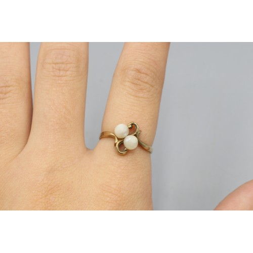 40 - Hallmarked 9ct yellow gold pearl toi et moi ring, comprised of two 4.8mm pearls in a scrollwork sett... 