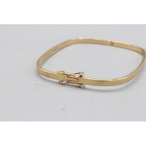 19 - Hallmarked 9ct yellow gold hinged bangle with rounded rectangular profile, 3mm width, fitted with a ... 