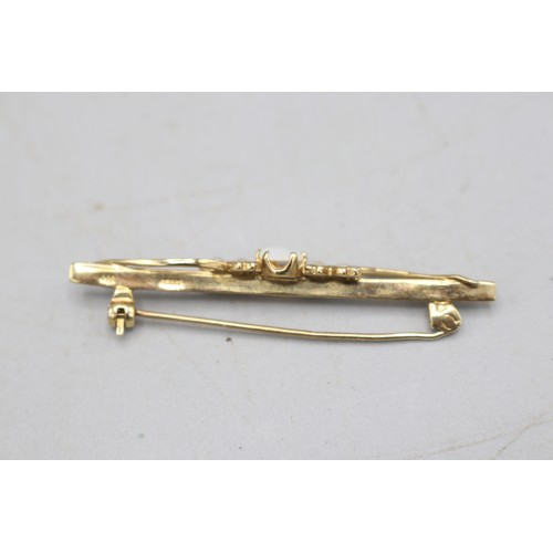 35 - Hallmarked 9ct yellow gold bar brooch, centrally set with an oval opal cabochon with hairline crack ... 